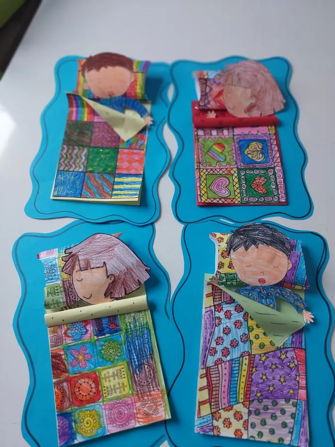 Drawings of children sleeping under patterned quilts