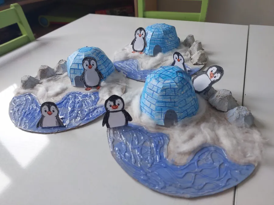 Igloo and penguin models made of cotton wool and paper